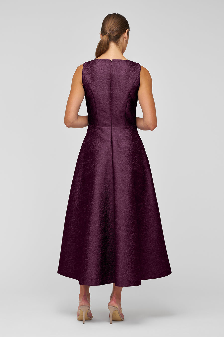 Woman wearing a purple dress on a white background