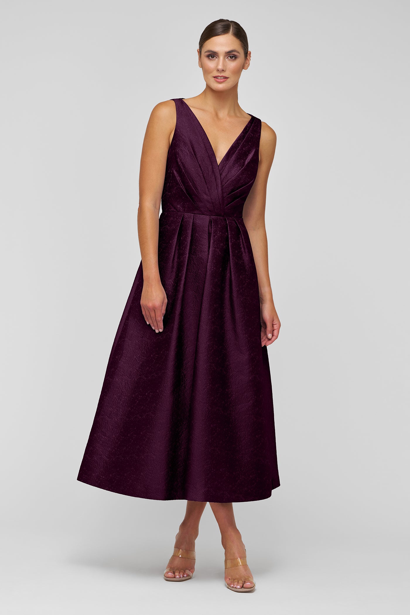 Woman wearing a purple dress on a white background