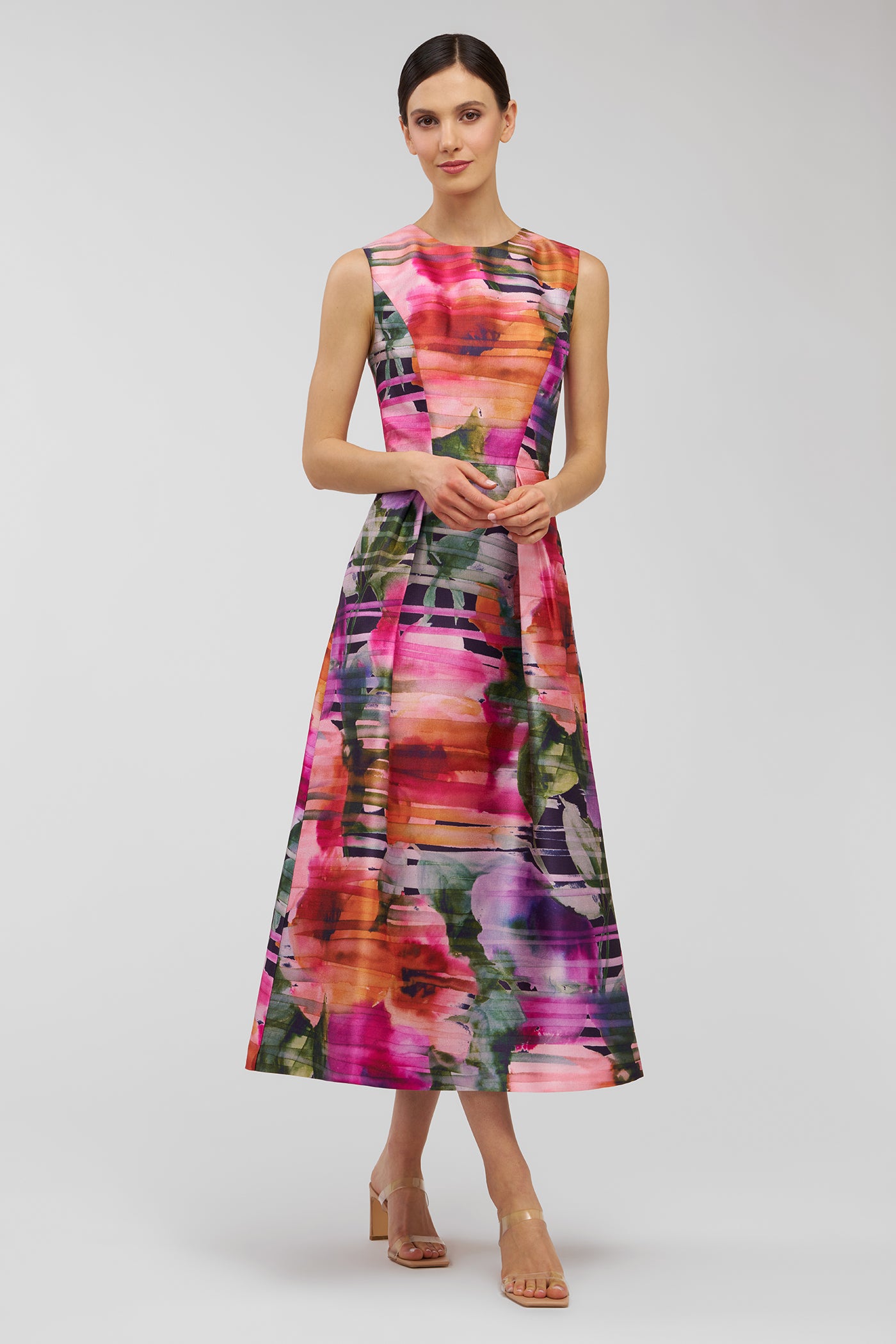 Woman wearing a colorful dress with a abstract pattern on a white background