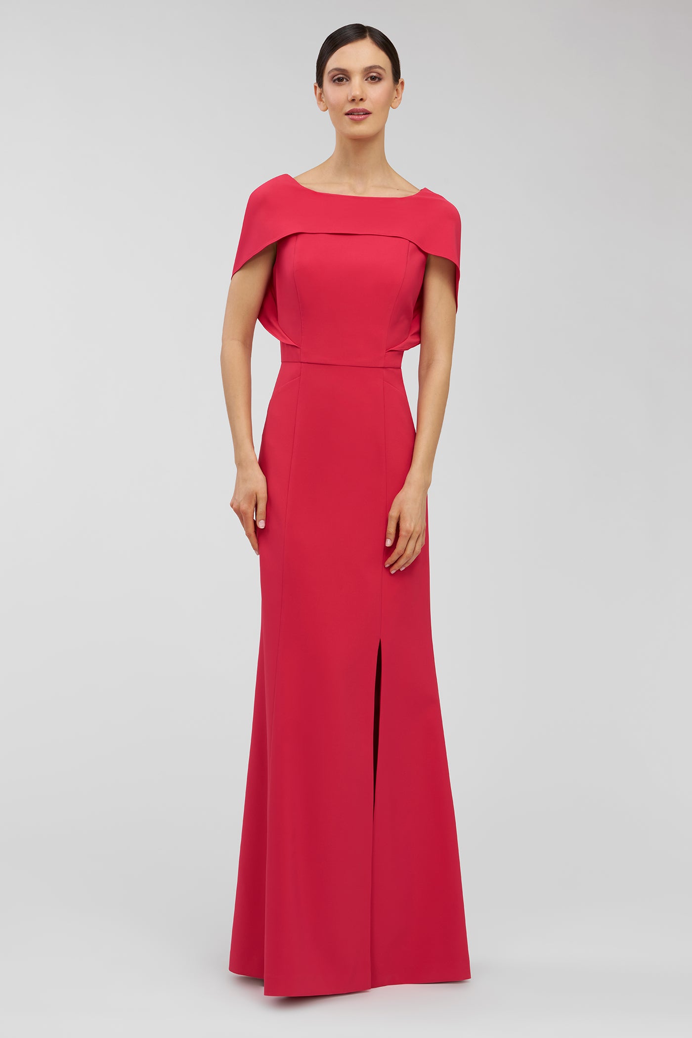 Woman wearing a red evening gown on a light gray background