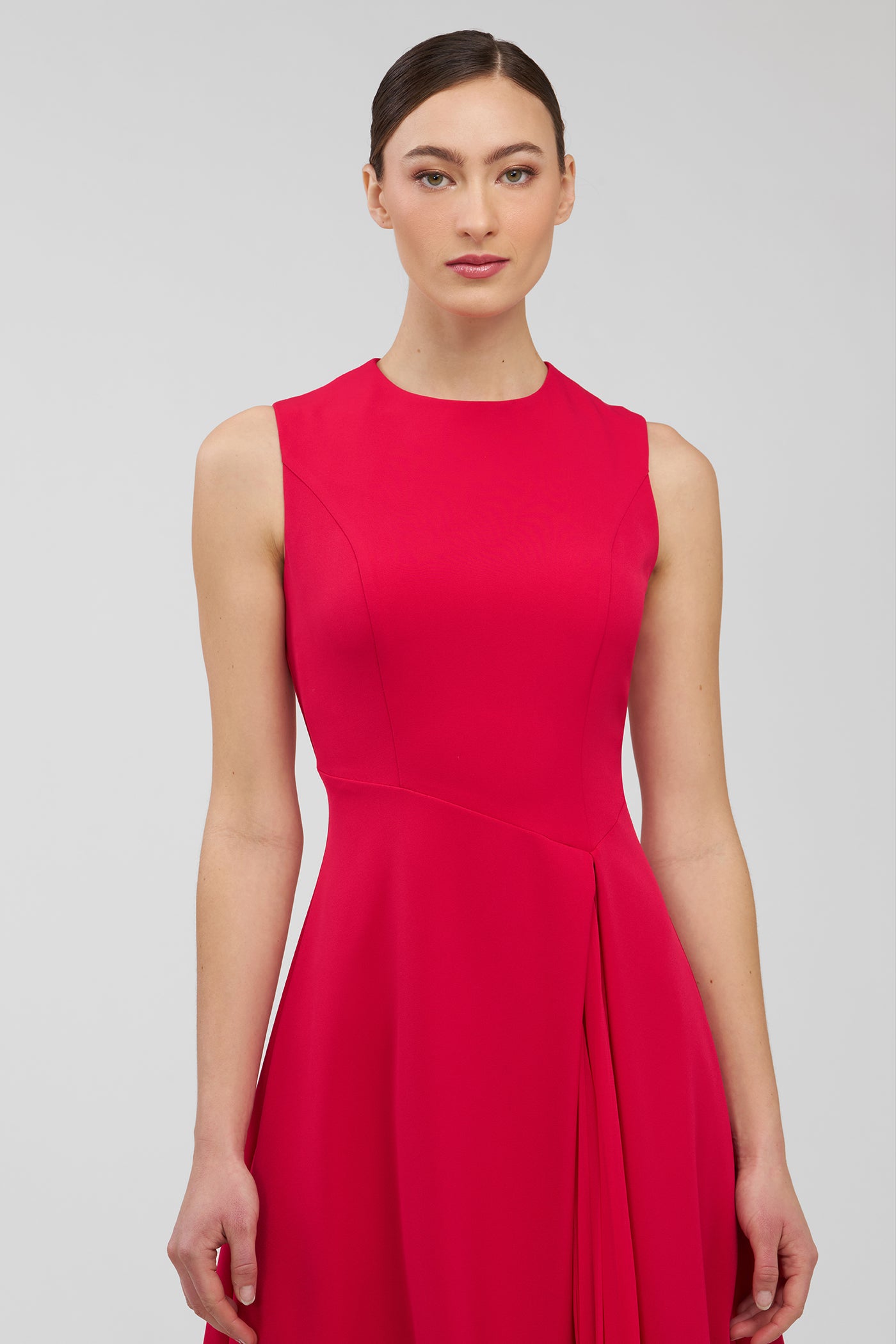 Woman wearing a red dress against a plain background
