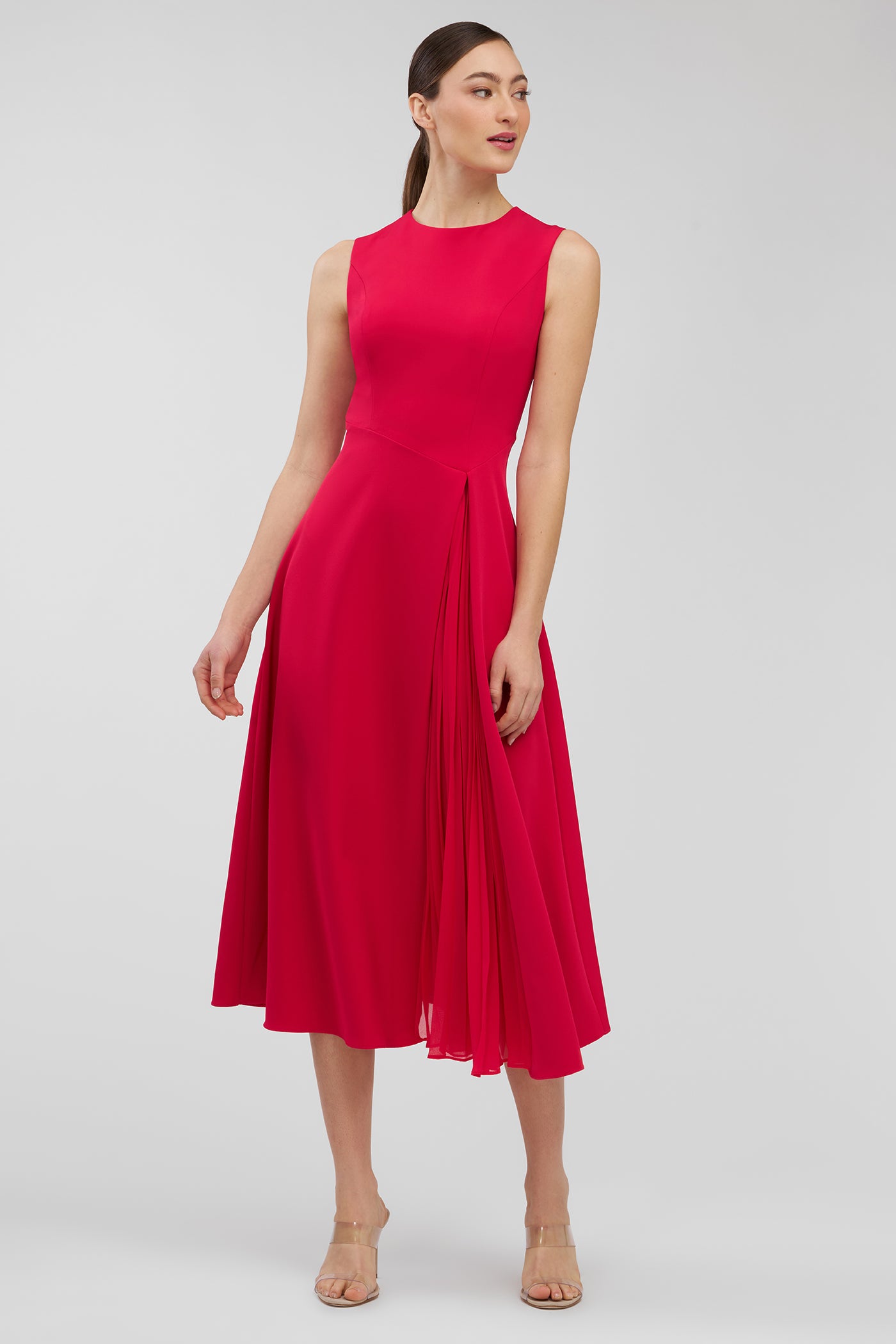 Woman wearing a red dress on a light gray background