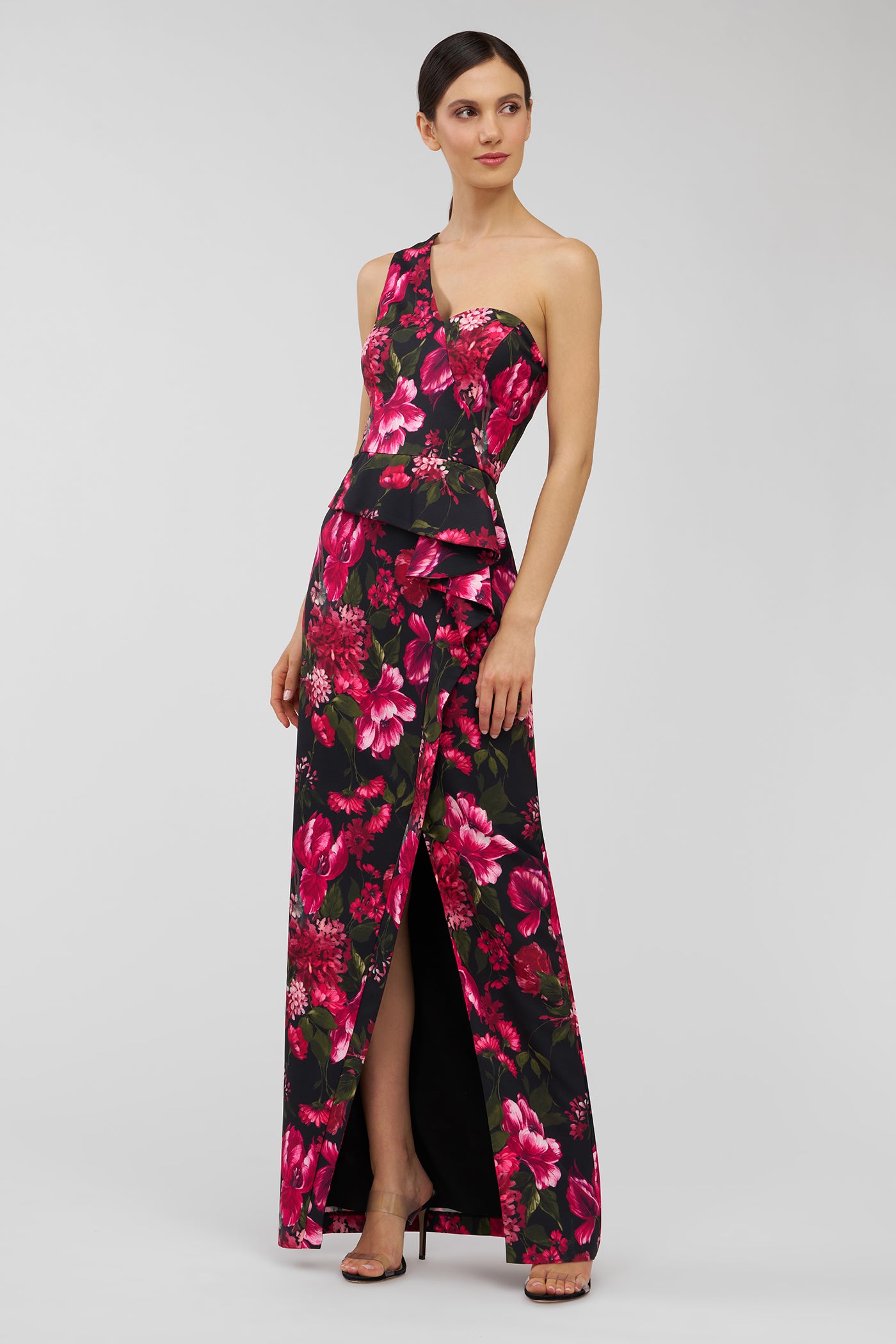 Woman wearing a floral one-shoulder dress on a white background