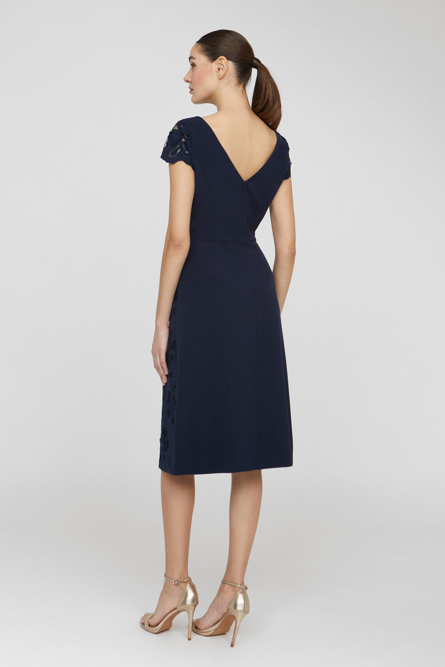 Navy blue dress with cap sleeves and a V-neckline on a white background