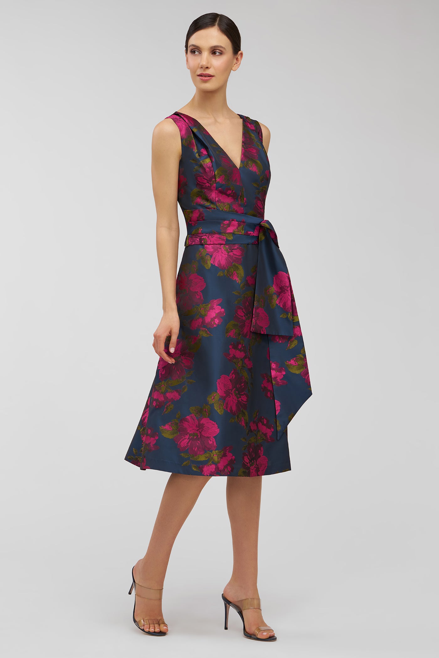 Woman wearing a floral dress on a light gray background