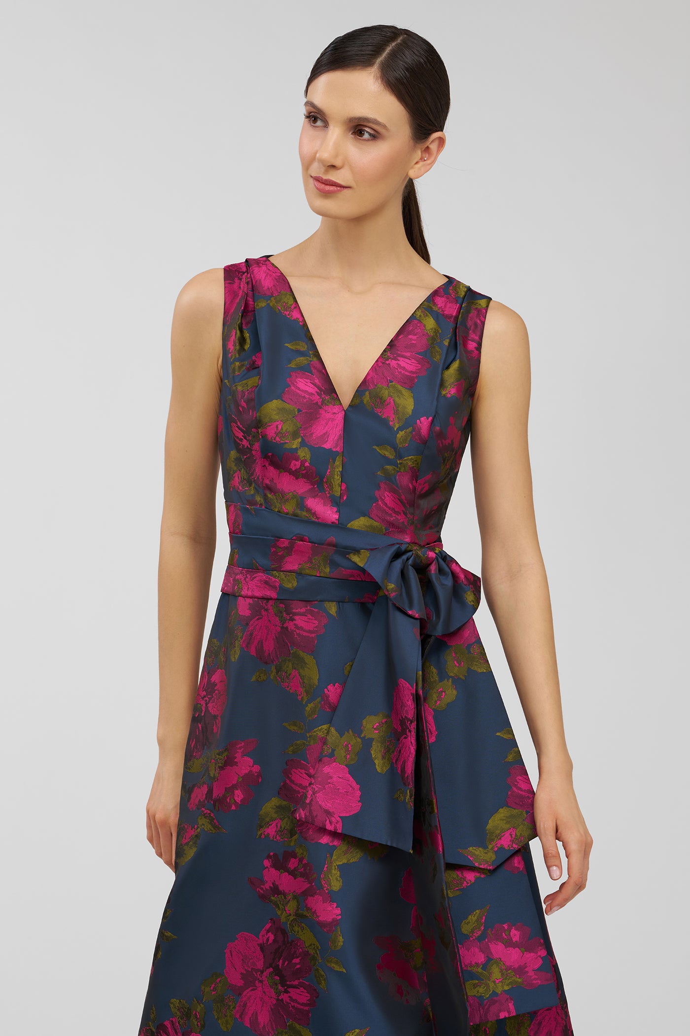 Woman wearing a floral dress with a plain background