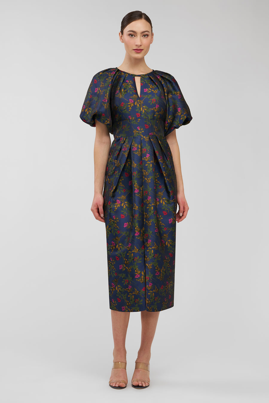 Woman wearing a floral dress on a white background