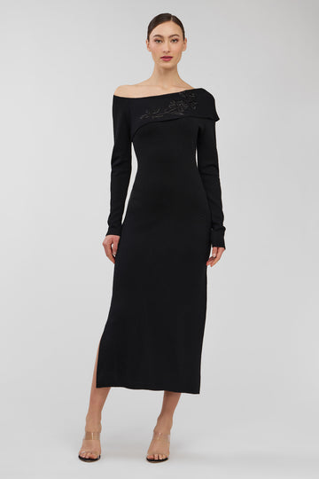 Black off-shoulder dress worn by a model on a white background