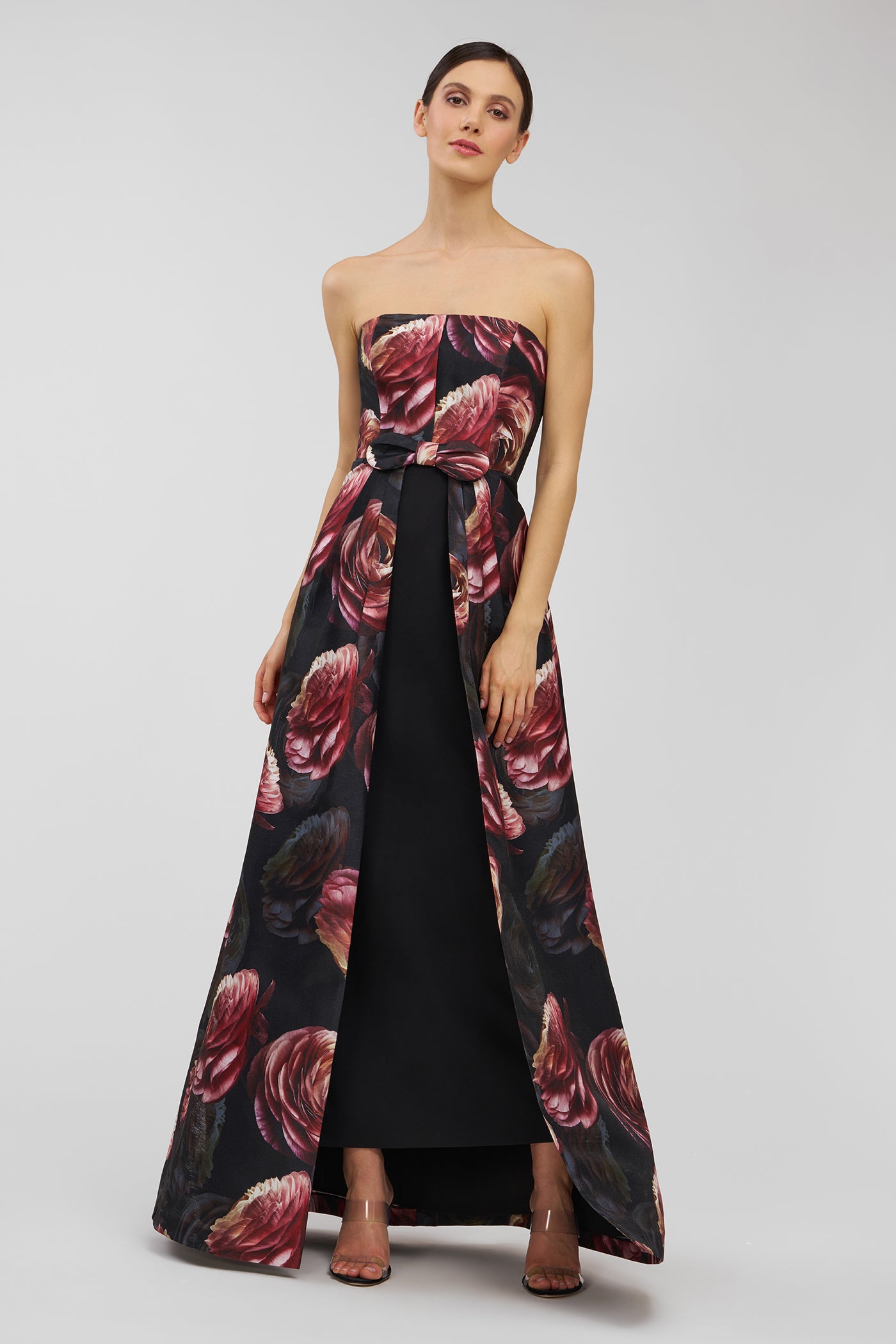 Woman wearing a strapless floral dress on a white background