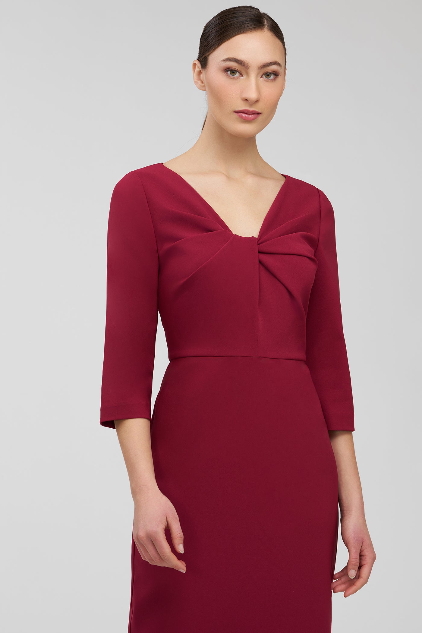 Red dress with a bow detail on a gray background