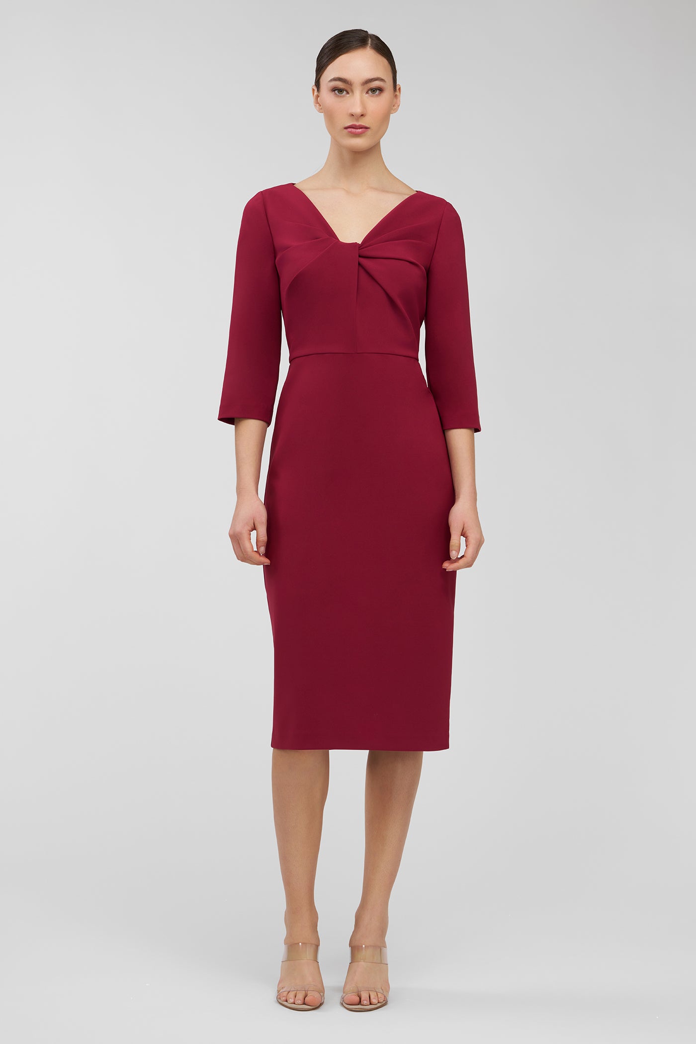 Woman wearing a burgundy dress with a plain background