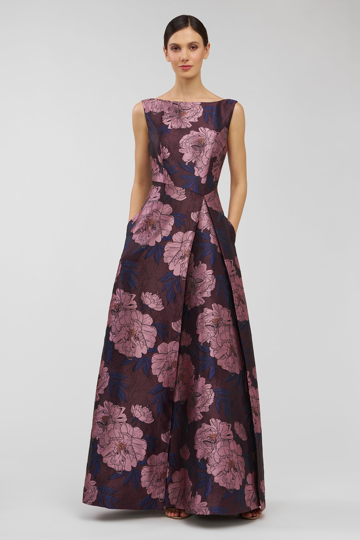 Woman wearing a floral evening gown on a white background