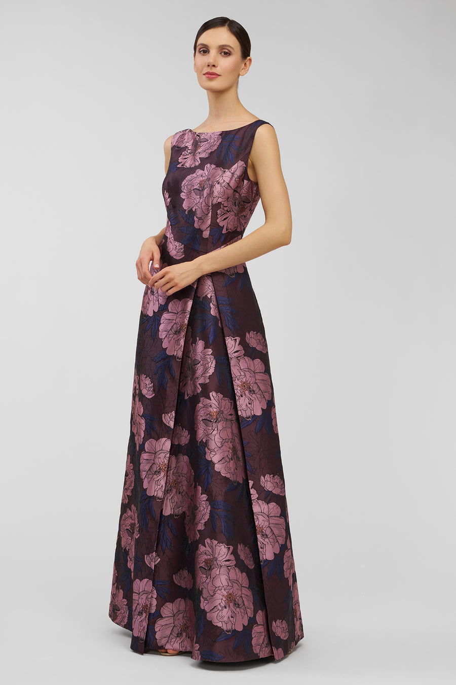 Woman wearing a floral patterned dress on a white background