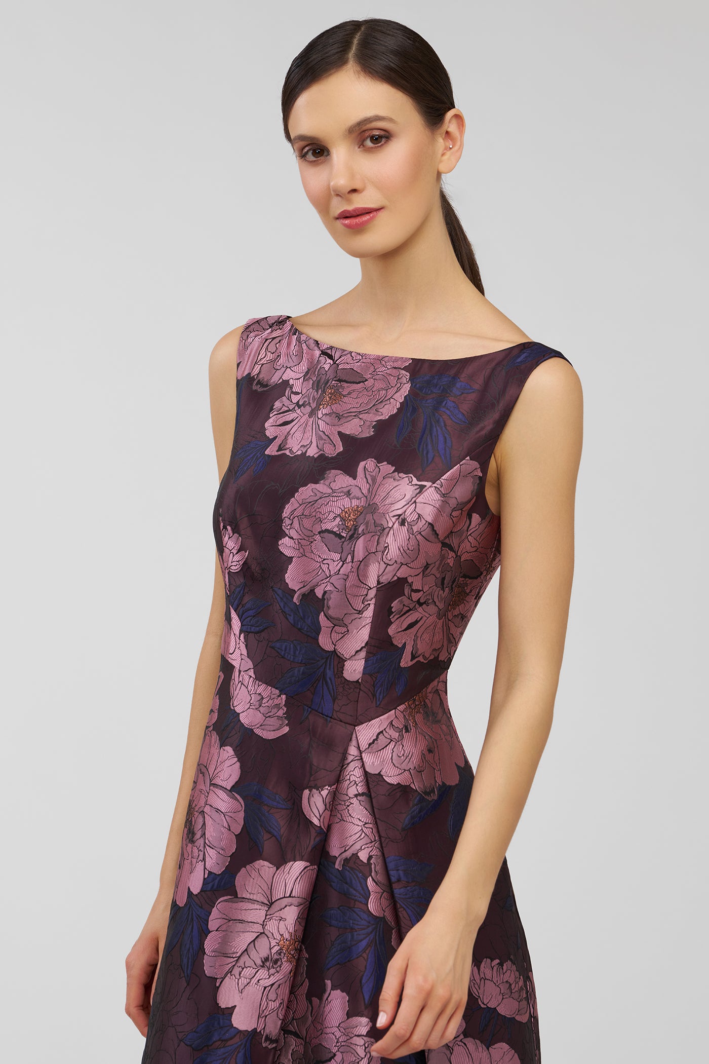 Woman wearing a floral dress on a plain background