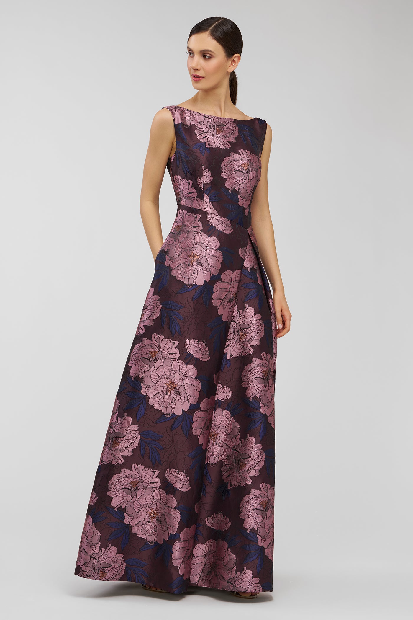 Woman wearing a floral dress on a plain background