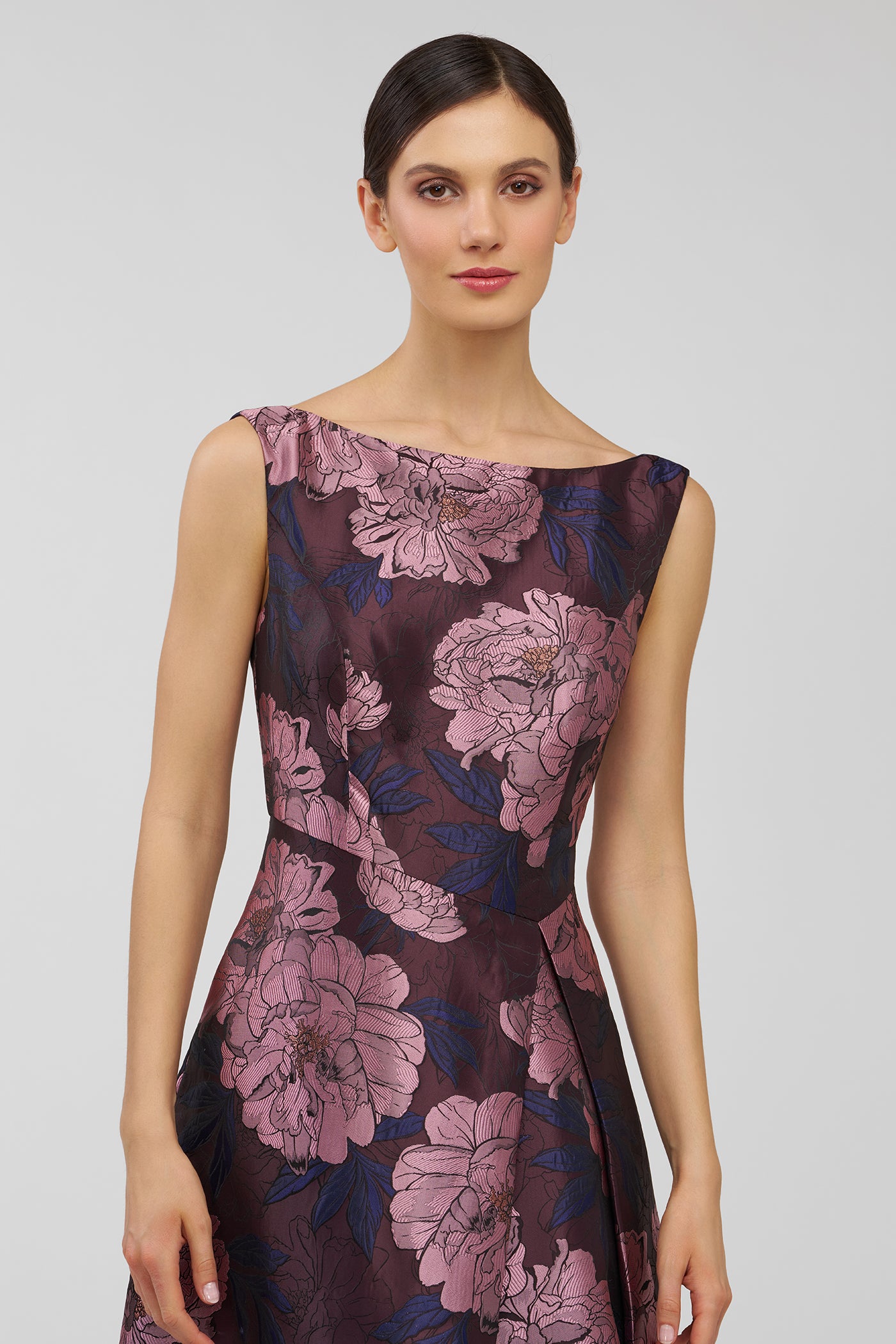 Woman wearing a floral dress on a plain background