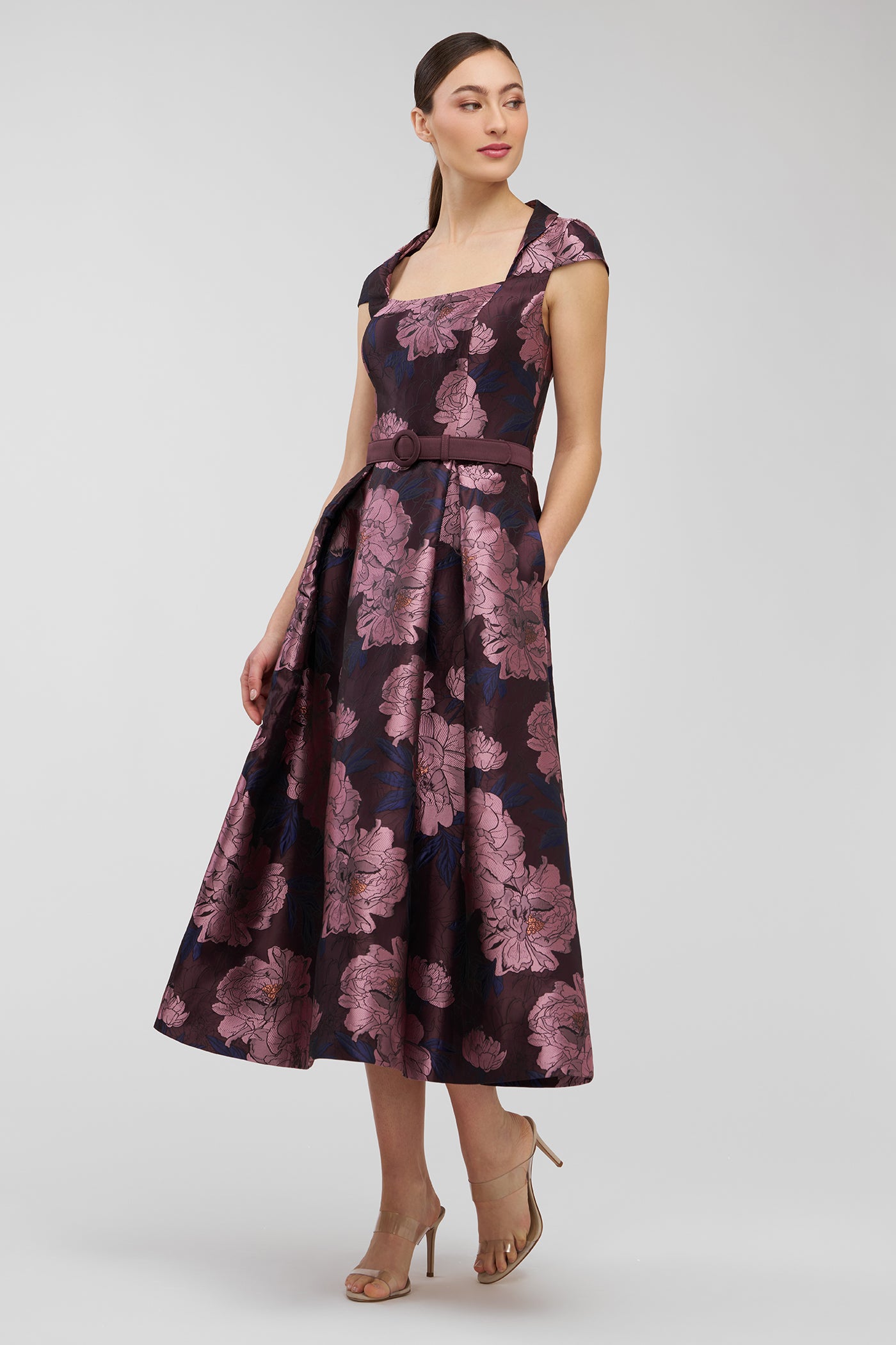 Woman wearing a floral dress on a white background