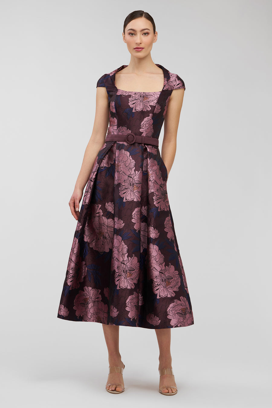 Woman wearing a floral patterned dress on a white background