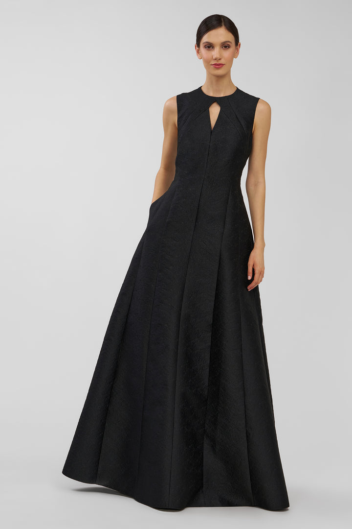 Black evening gown on a model against a plain background