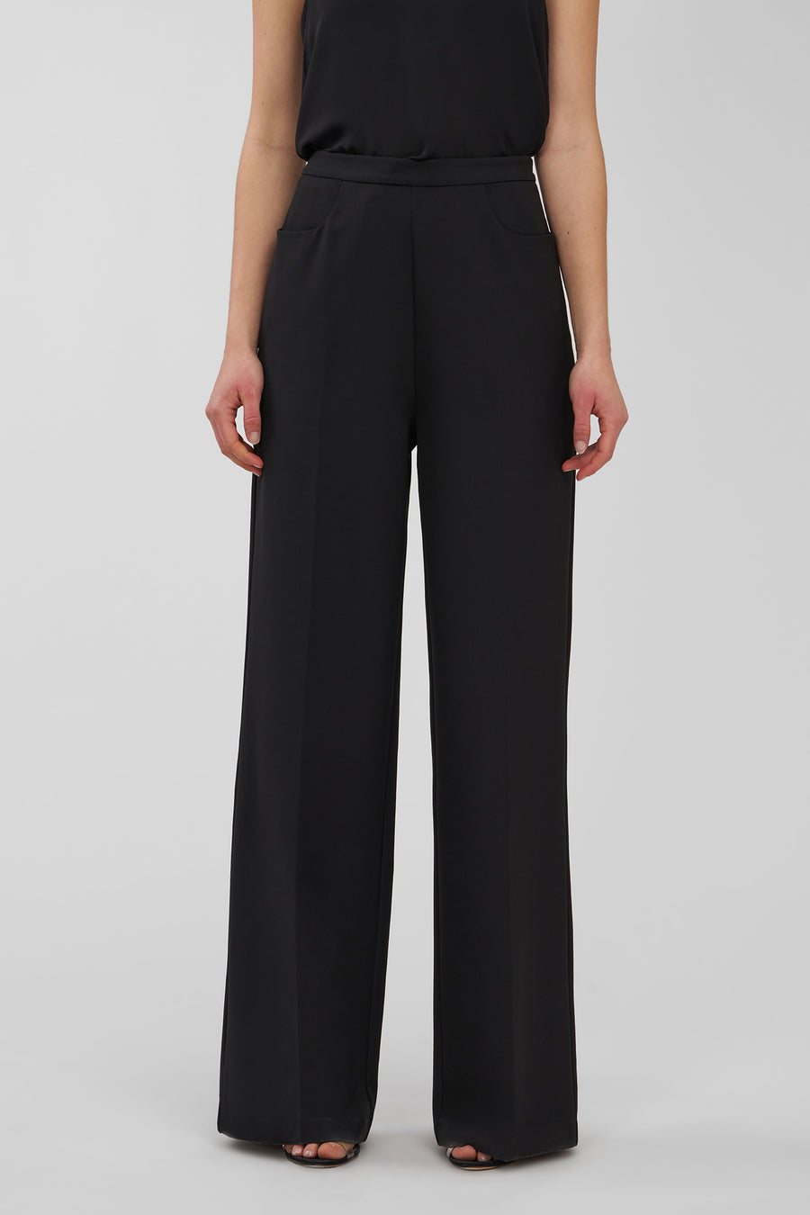 Black wide-leg pants worn by a person on a white background