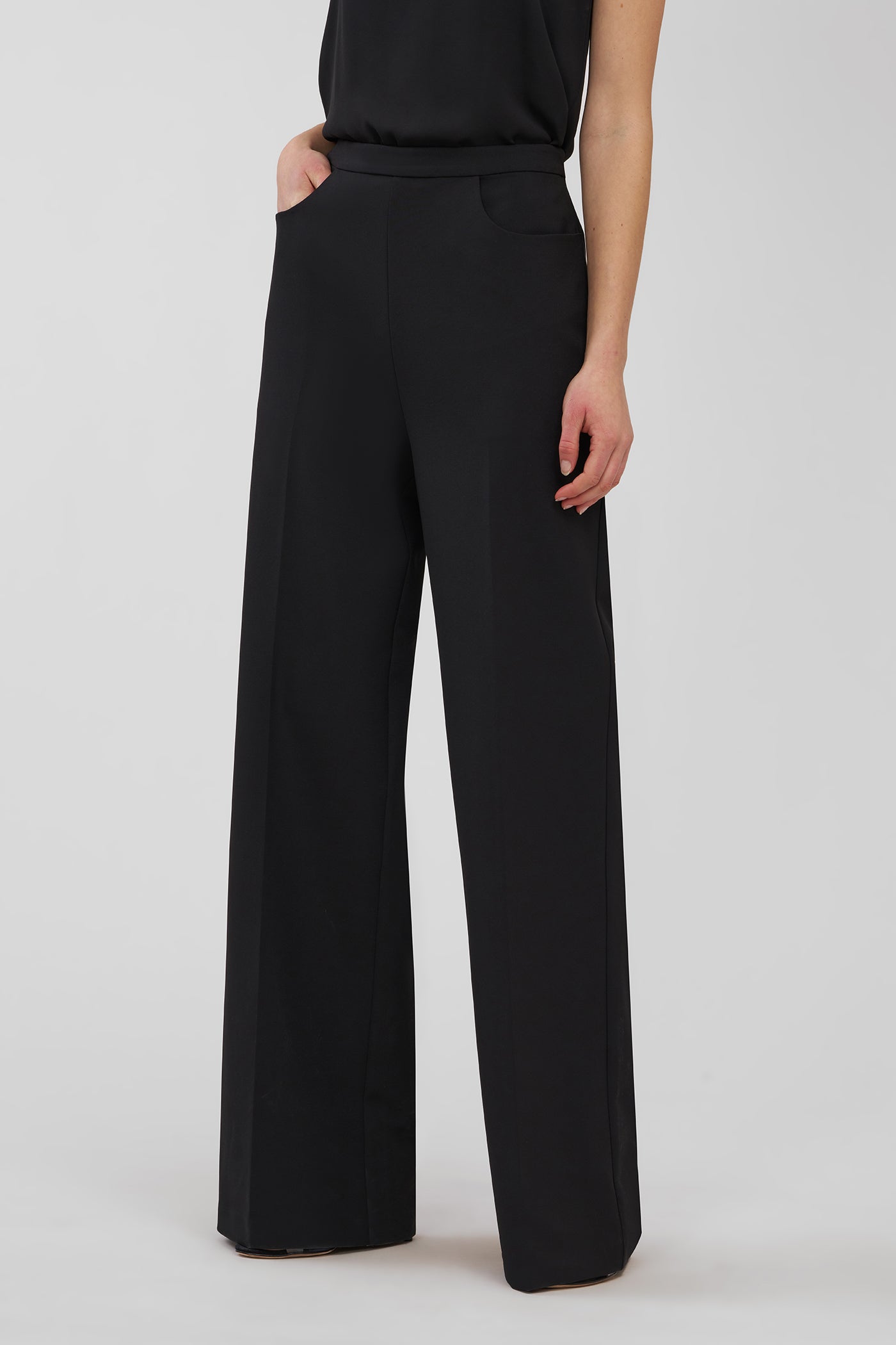 Black wide-leg pants worn by a person on a light gray background