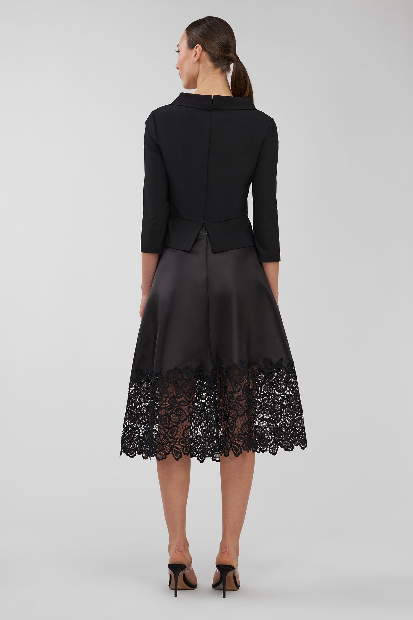 Black skirt with lace hem on a gray background