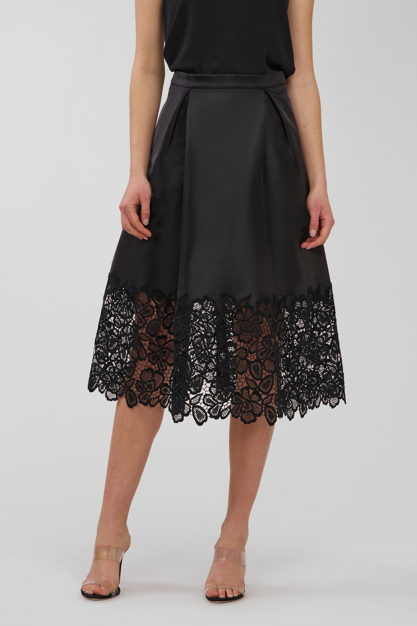 Black dress with lace detailing on a white background