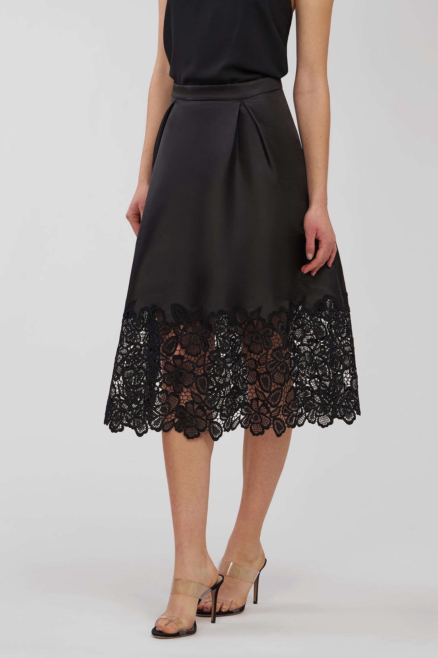 Black skirt with lace detailing on a white background