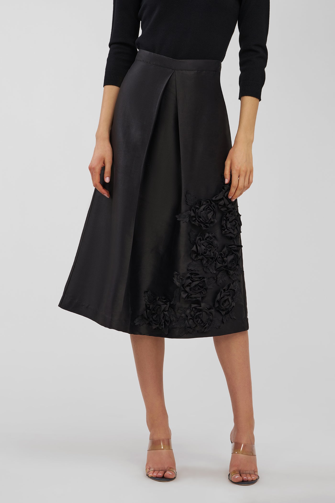 Black skirt with floral lace details on a white background