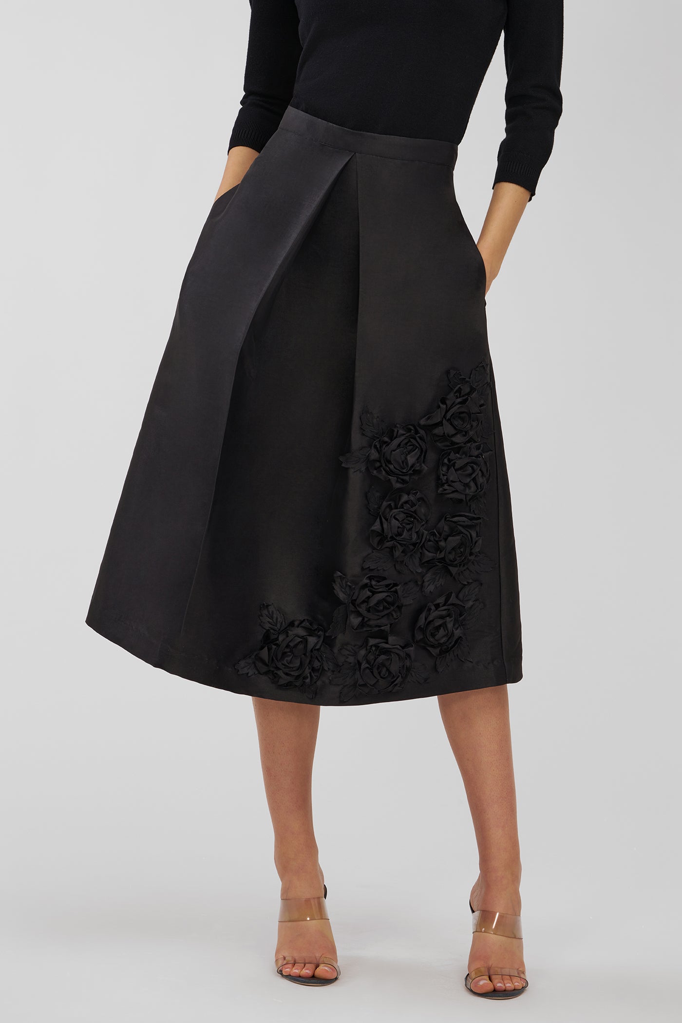 Black skirt with floral embellishments on a white background