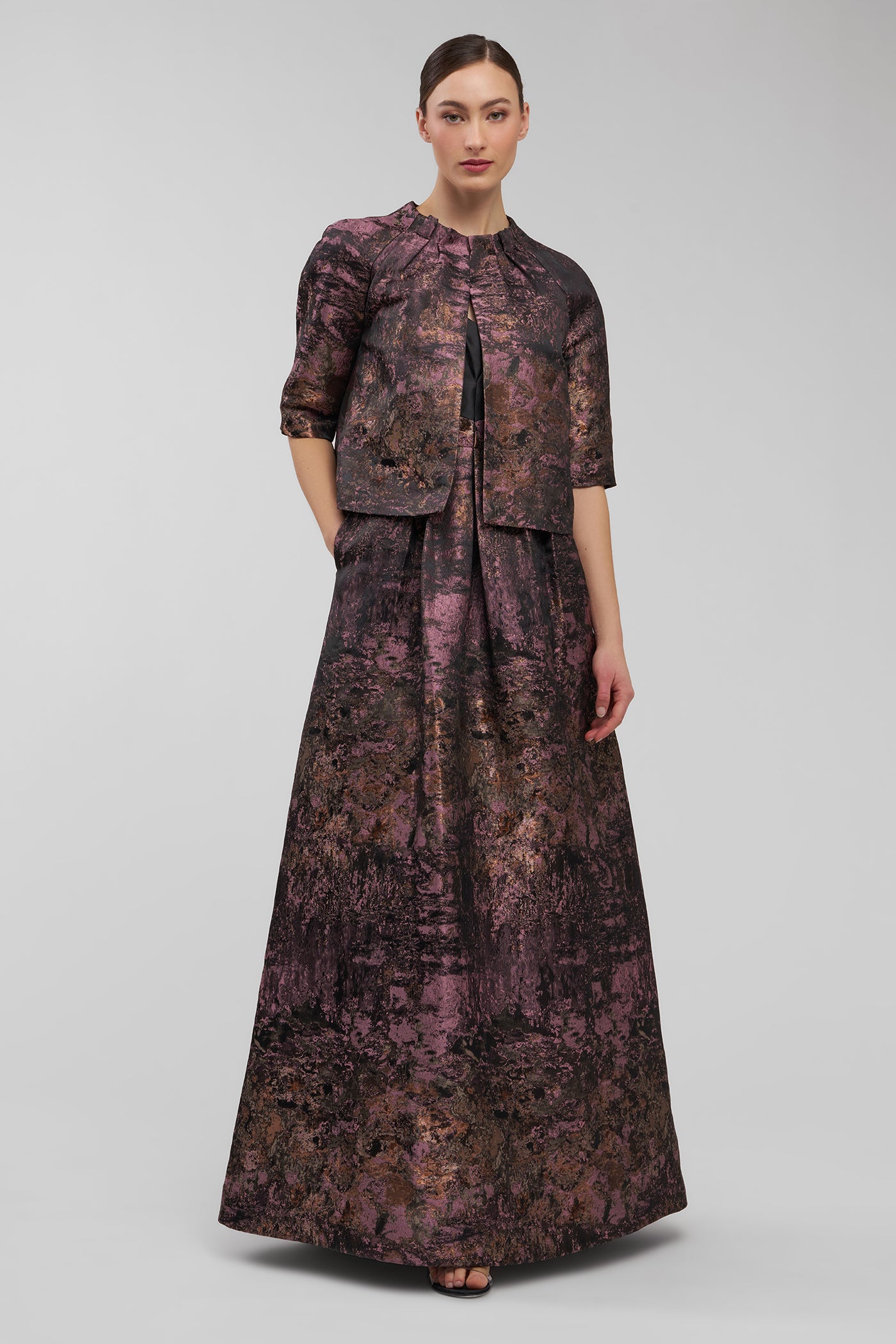 Woman wearing a patterned outfit on a gray background
